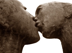 statue of man and woman kissing