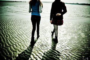 Friends Walking on Beach at Sunset