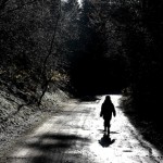 Boy alone on country road