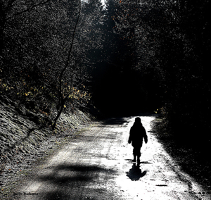 Boy alone on country road