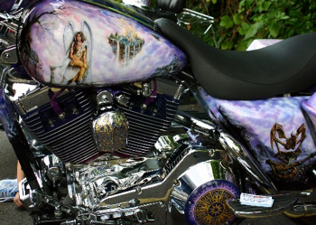 chrome-plated motorcycle engine with painting of girl