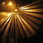 Bench shimmering in night rain