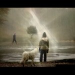 Boy standing by a frozen river