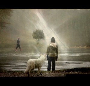 Boy standing by a frozen river